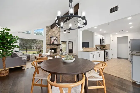a dining room with furniture and wooden floor