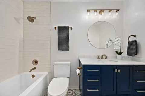 a bathroom with a toilet sink and mirror