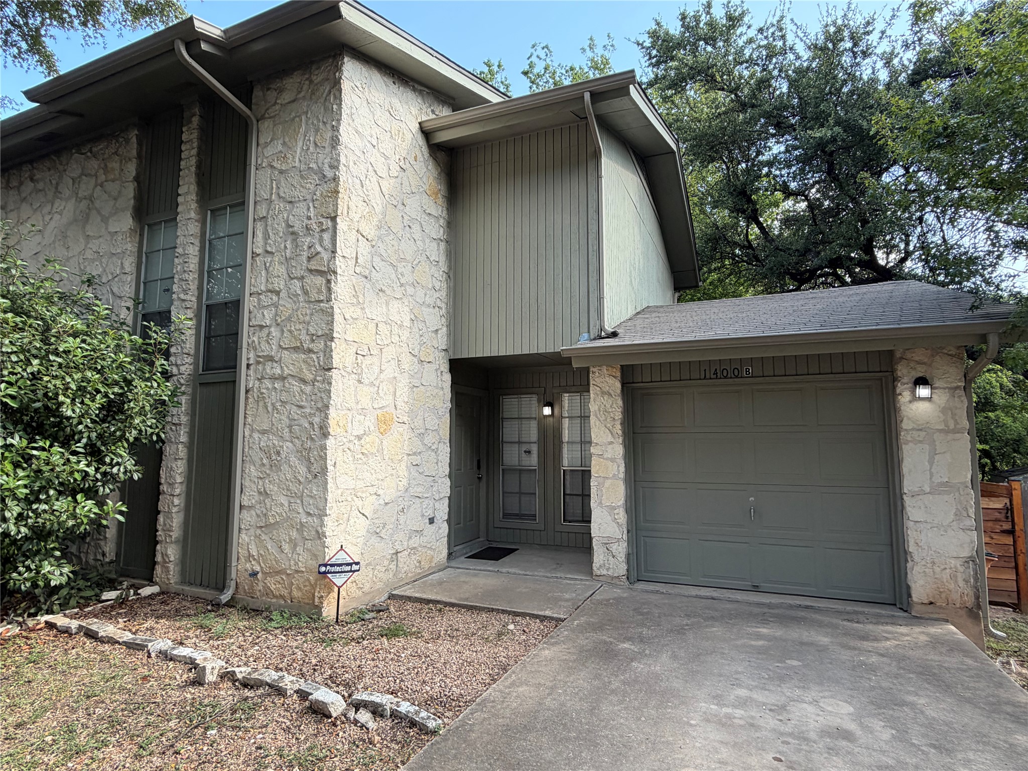 1400 Vista Ridge Cove, Unit B Austin, TX 78754 - Photo 2 of 25 A striking facade with varied textures presents a welcoming curb appeal.