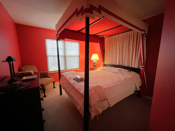 a bed room with a bed and a potted plant