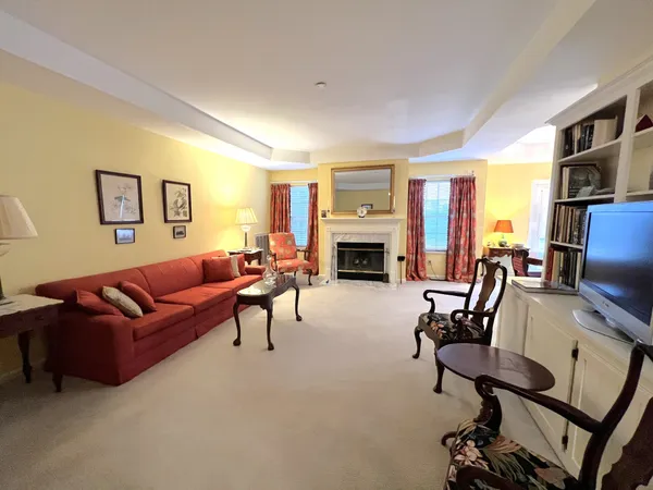 a living room with furniture flat screen tv and a fireplace