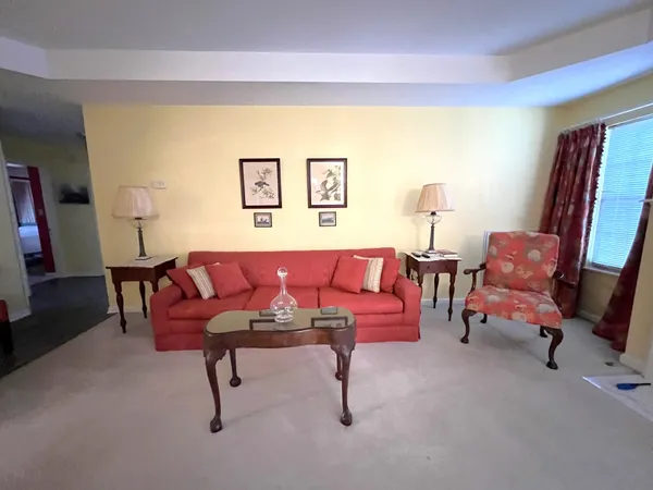 a living room with furniture and a chair