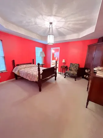 a living room with furniture gym equipment and a chandelier