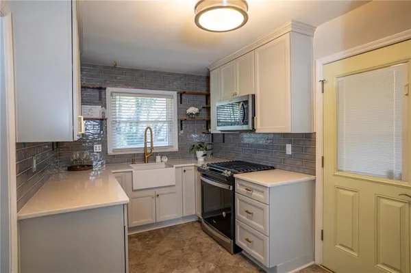 a kitchen with a sink stove and cabinets