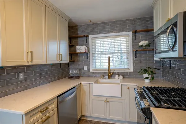 a kitchen that has a sink and a stove in it
