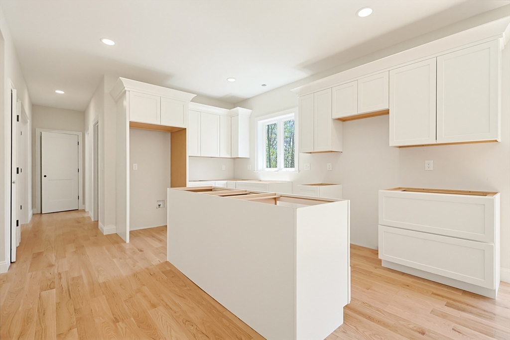 112 West Meadow Road Townsend, MA 01474 - Photo 8 of 38 a kitchen with a refrigerator a stove top oven and white cabinets