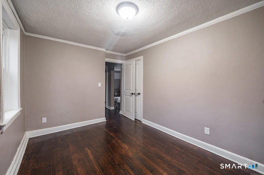 73 Silver Street Middletown, CT 06457 - Photo 18 of 30 a view of an empty room with wooden floor
