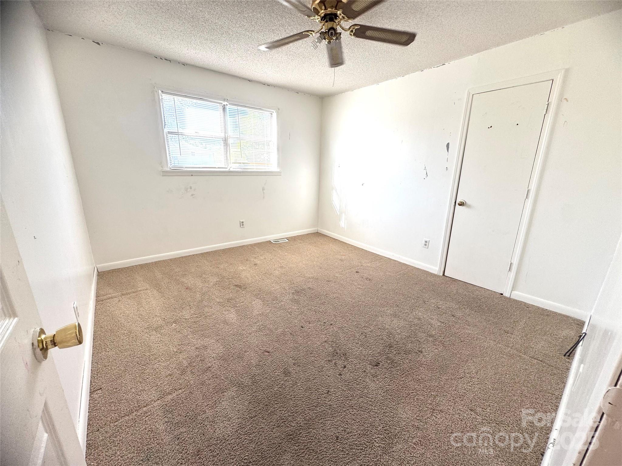 294 Mizpah Road Rockingham, NC 28379 - Photo 11 of 12 an empty room with a window and a fan