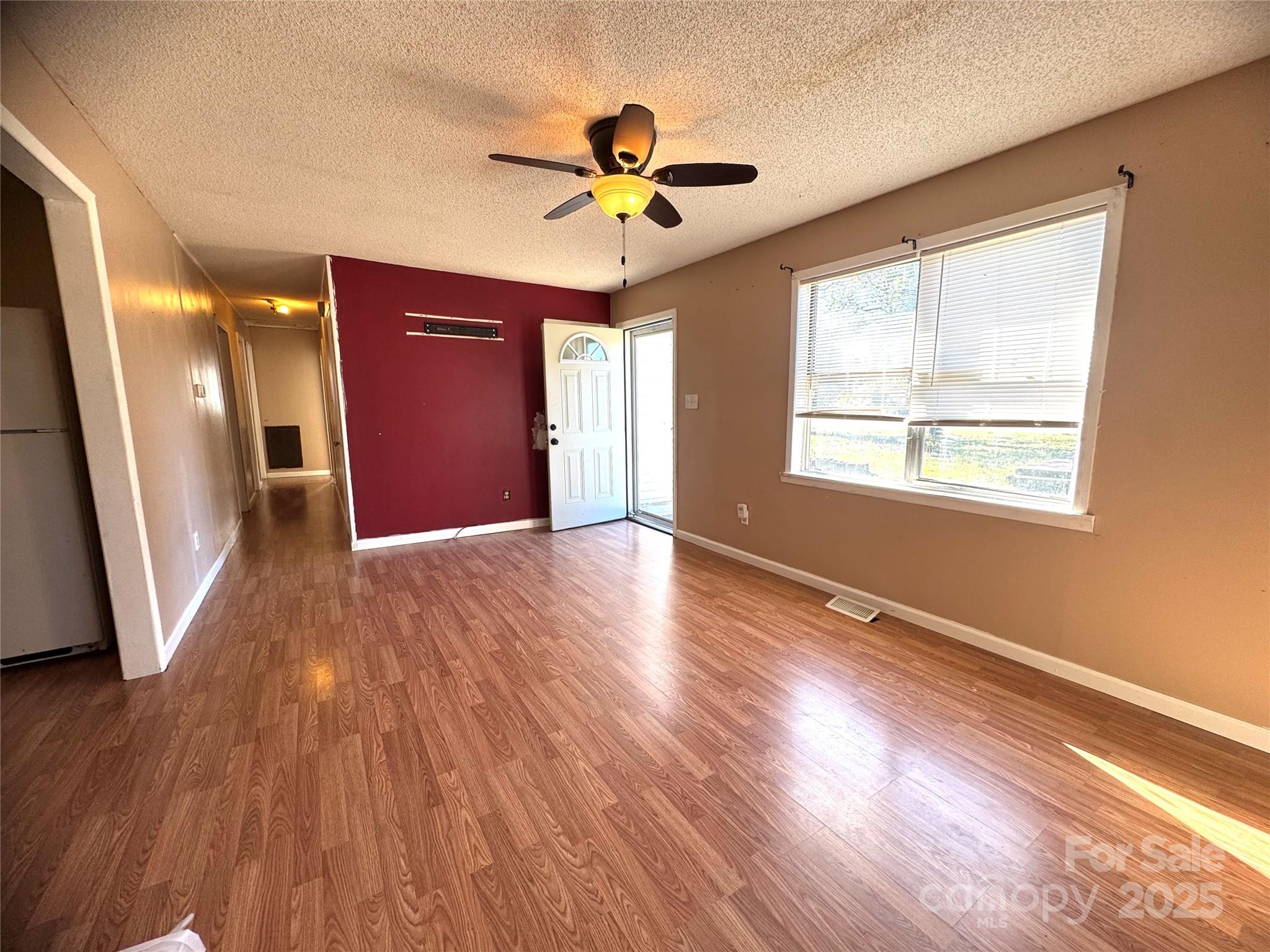 294 Mizpah Road Rockingham, NC 28379 - Photo 3 of 12 a view of an empty room with a window and wooden floor