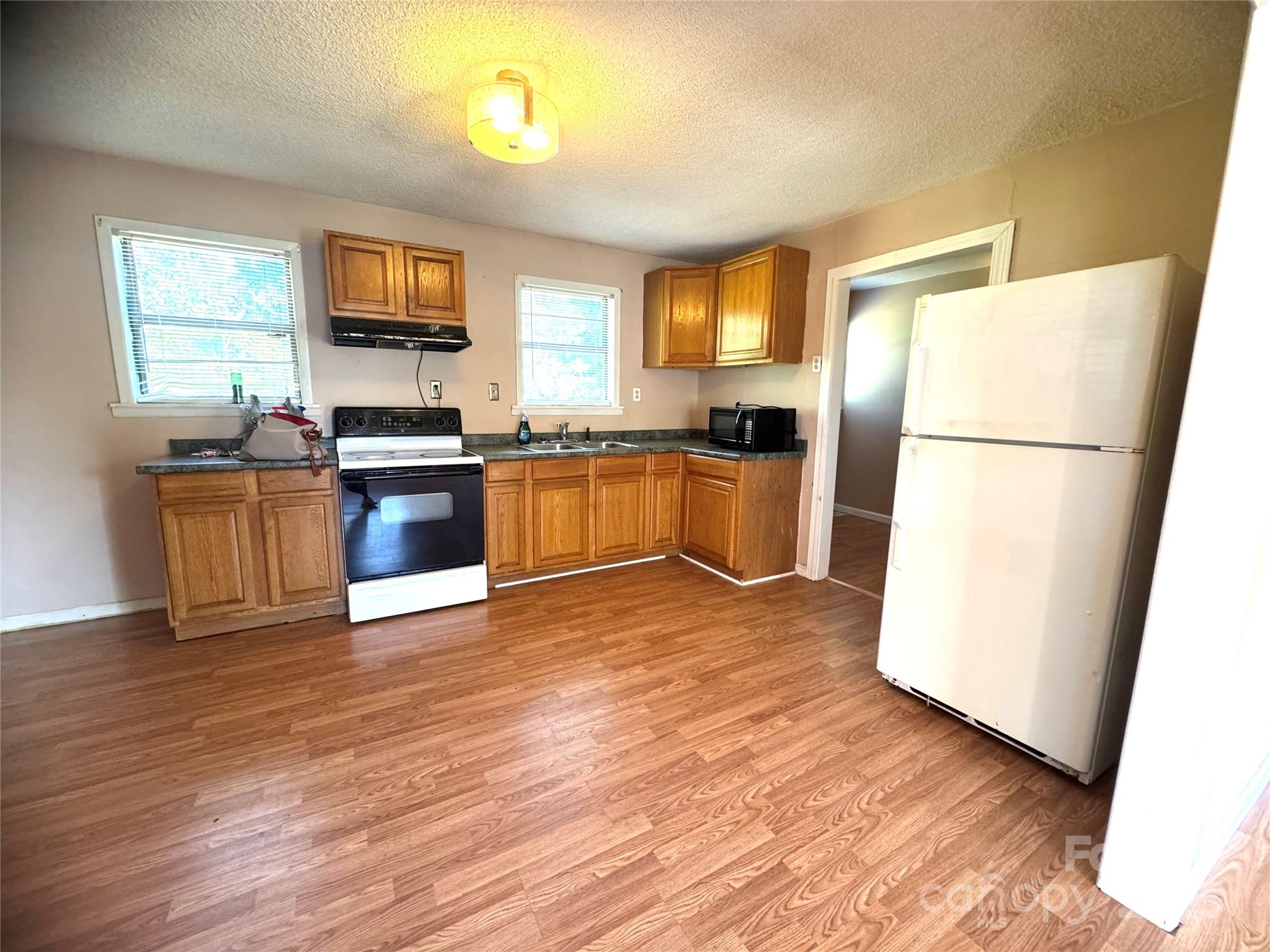 294 Mizpah Road Rockingham, NC 28379 - Photo 4 of 12 a kitchen with granite countertop a refrigerator stove top oven and sink