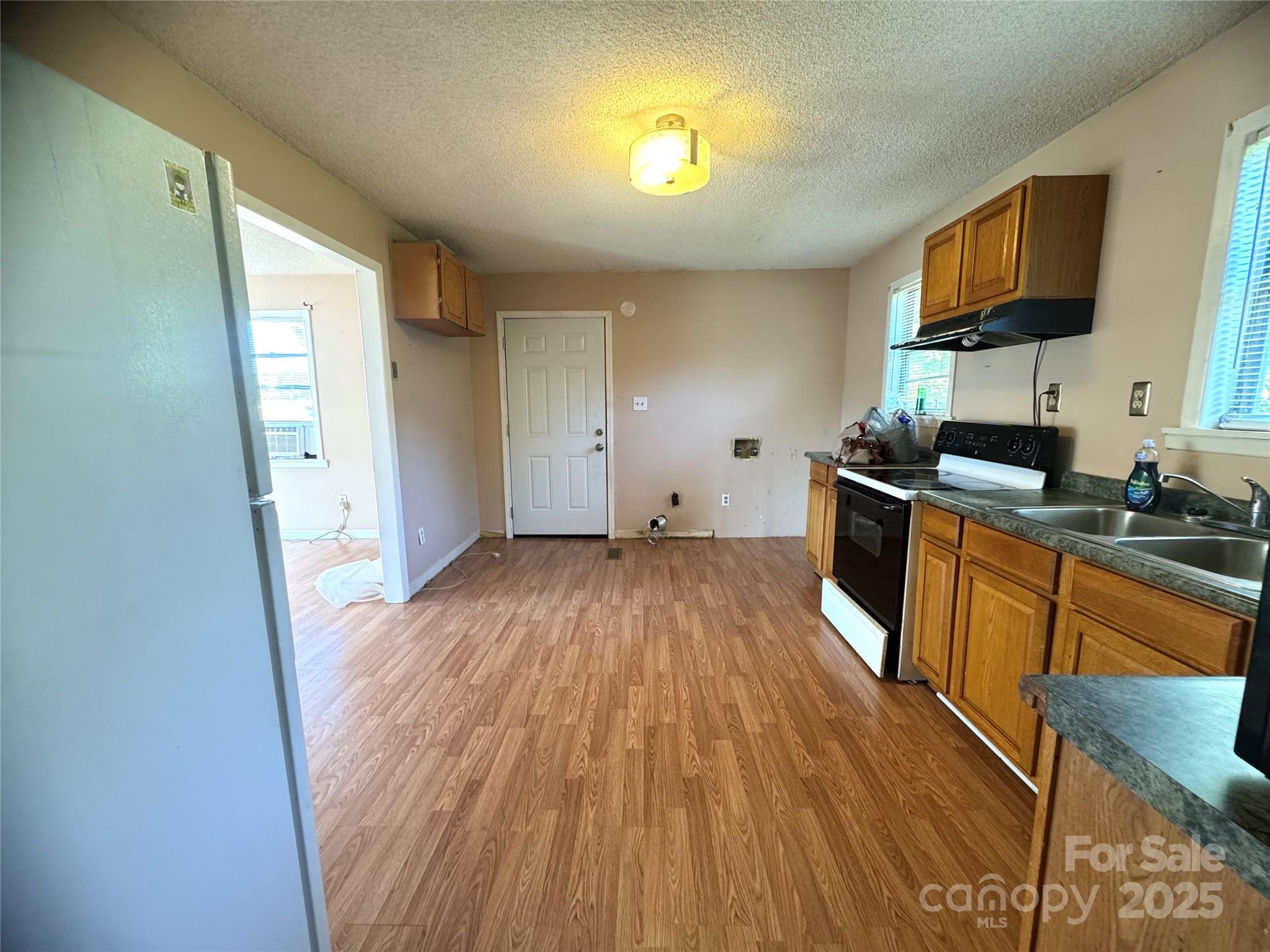 294 Mizpah Road Rockingham, NC 28379 - Photo 5 of 12 a kitchen with wooden floors and a sink