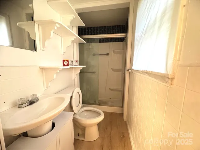 a bathroom with a toilet and a shower