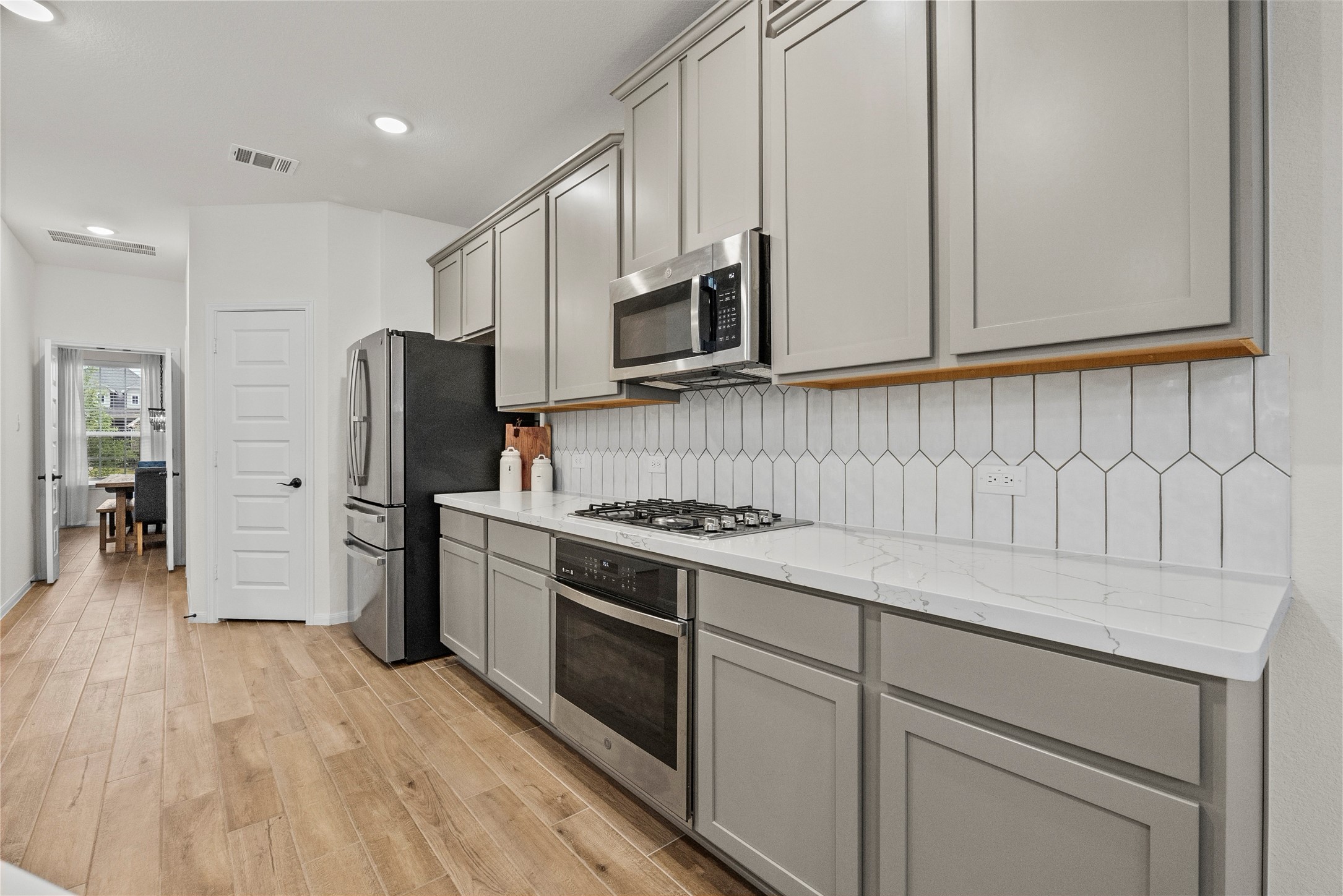 2727 Bisbee Road League City, TX 77573 - Photo 10 of 47 Maplewood cabinets and calacatta Quartz