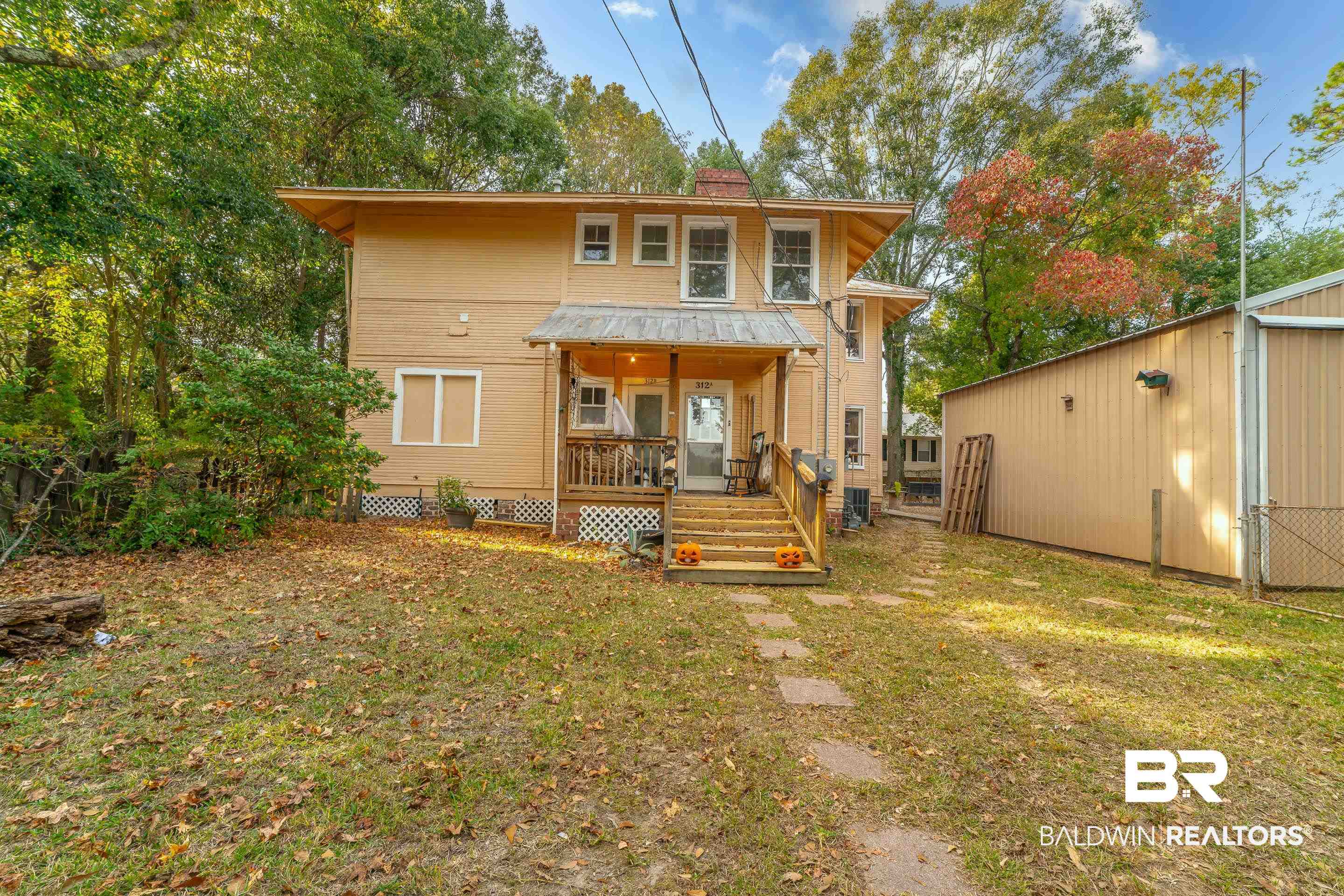 312 1st Street Mobile, AL 36611 - Photo 28 of 29 Rear view of house featuring covered porch, a yard, and cooling unit