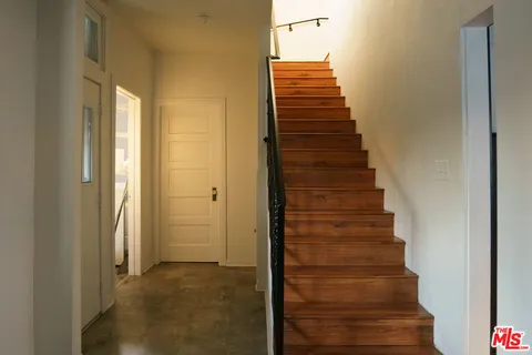 a view of entryway and gallery with wooden floor