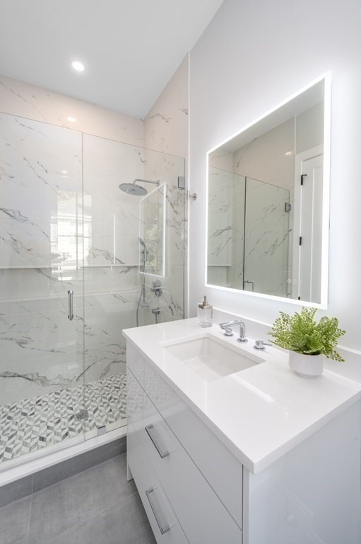 142 Bellingham Road Chestnut Hill, MA 02467 - Photo 14 of 37 a bathroom with a sink mirror and a shower