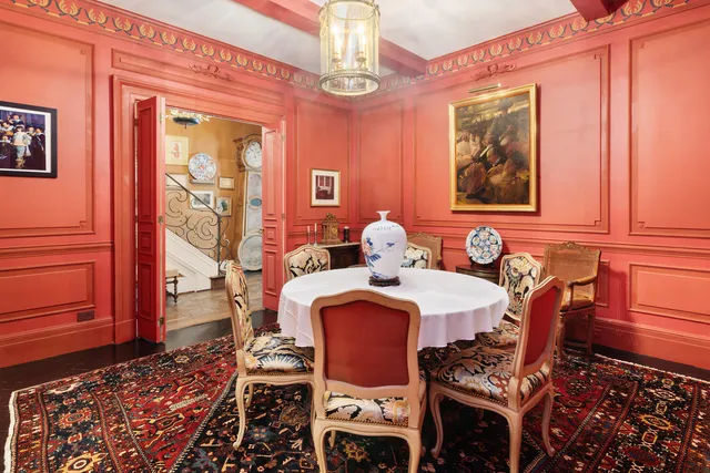 a dining room with furniture a chandelier and window