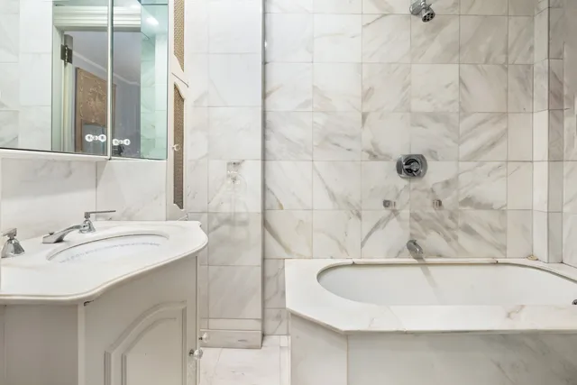 a bedroom with a bed table and chairs