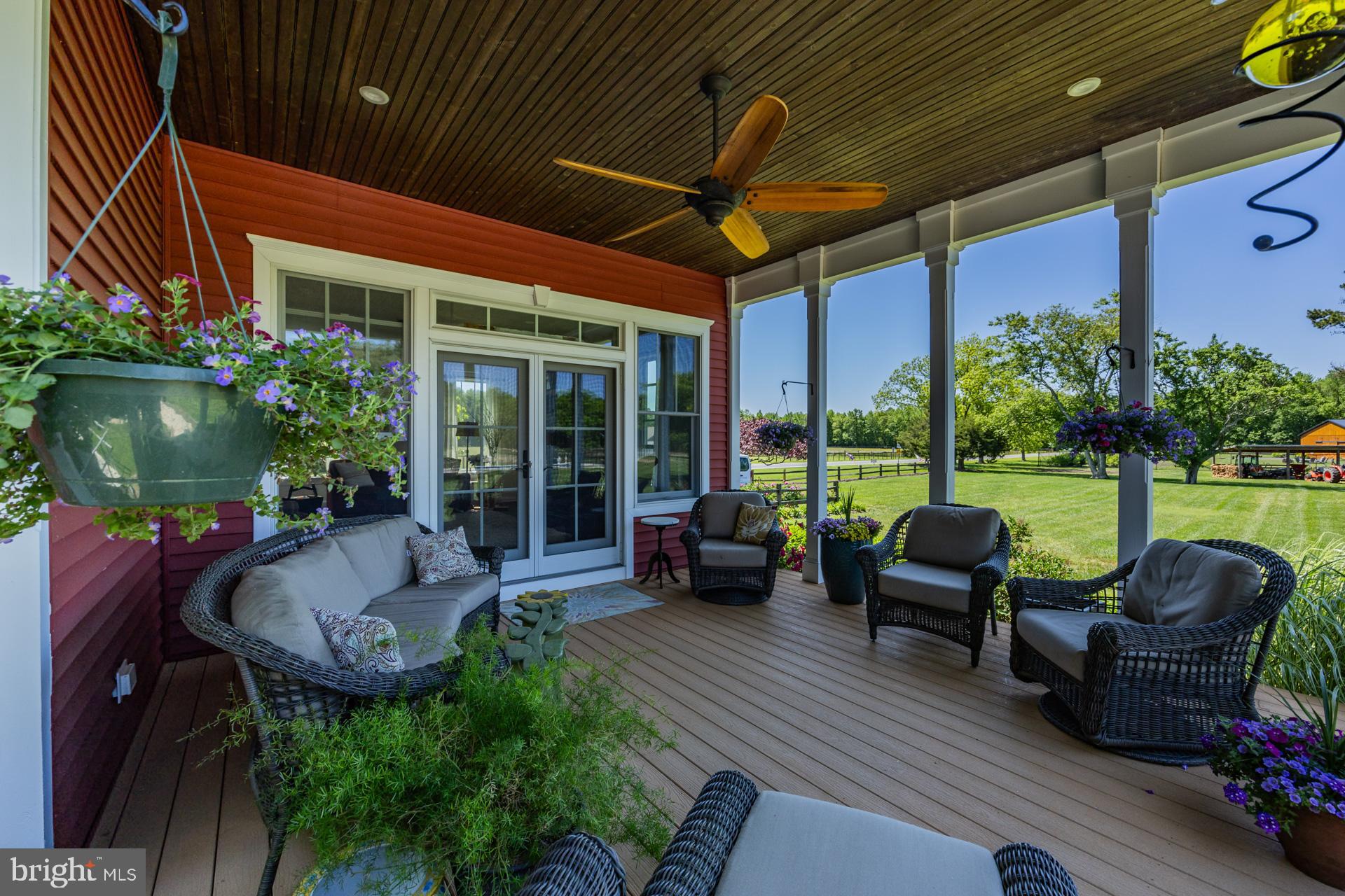 550 Hands Mill Road Woodbine, NJ 08270 - Photo 16 of 57 a view of a patio with couches table and chairs potted plants with wooden floor and fence