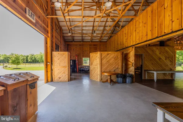 a living room with furniture a fireplace and a chandelier