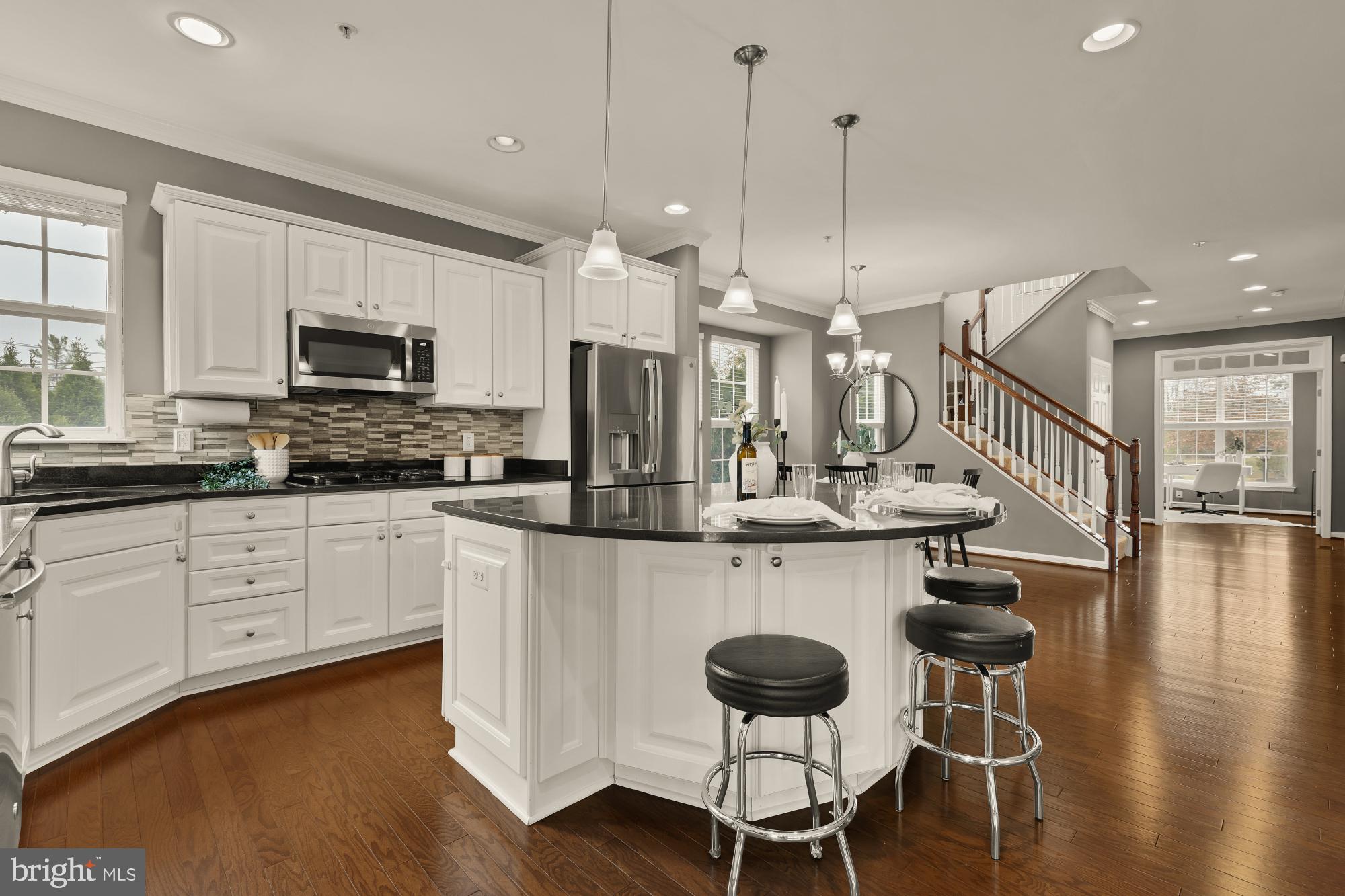 15611 Coolidge Avenue Silver Spring, MD 20906 - Photo 11 of 57 a kitchen with stainless steel appliances kitchen island granite countertop a dining table chairs and granite counter tops