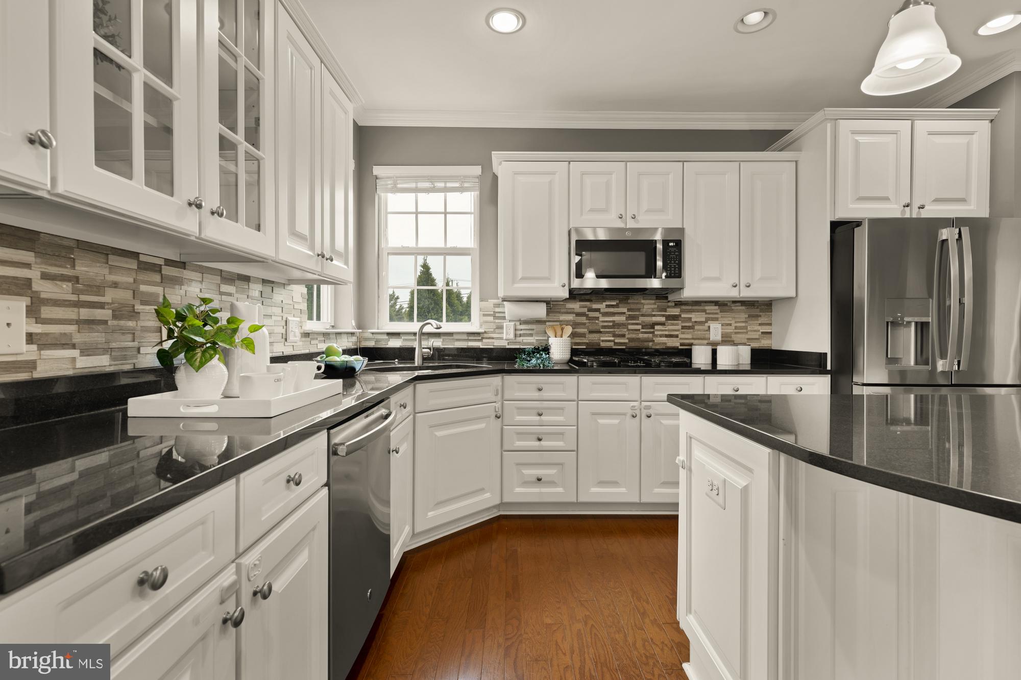 15611 Coolidge Avenue Silver Spring, MD 20906 - Photo 12 of 57 a kitchen with stainless steel appliances granite countertop a refrigerator a stove a sink and white cabinets