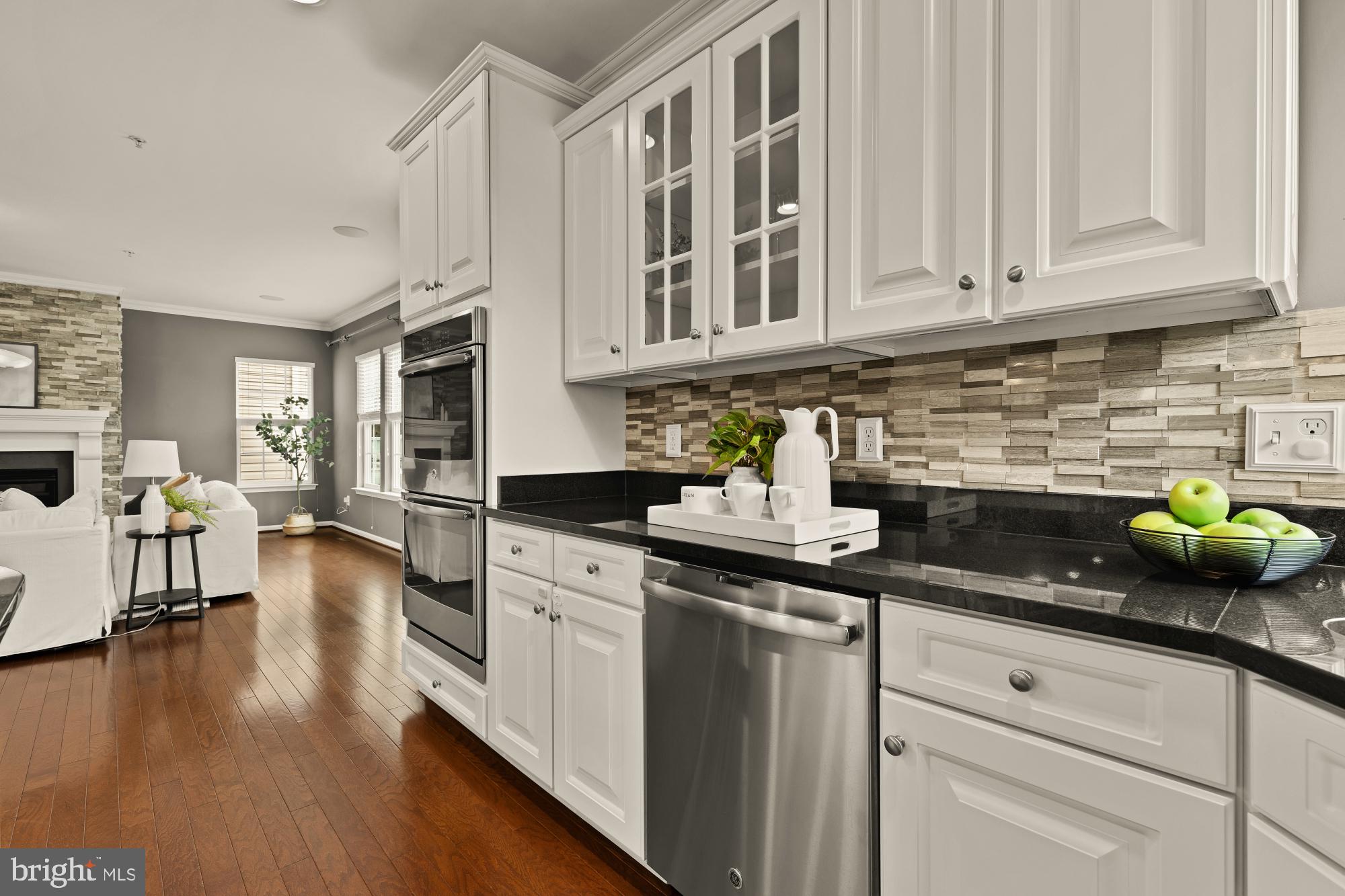 15611 Coolidge Avenue Silver Spring, MD 20906 - Photo 13 of 57 a kitchen with stainless steel appliances granite countertop a stove and white cabinets with wooden floor