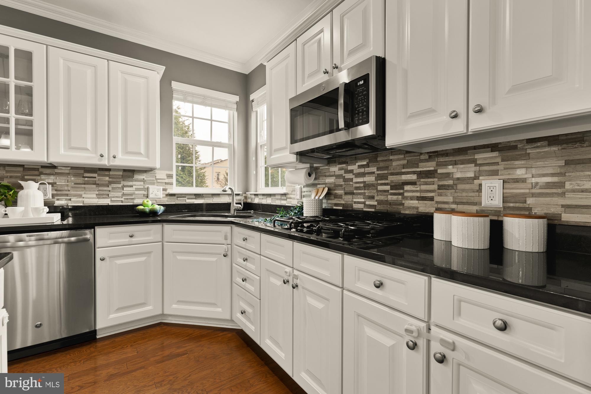15611 Coolidge Avenue Silver Spring, MD 20906 - Photo 17 of 57 a kitchen with white cabinets and window