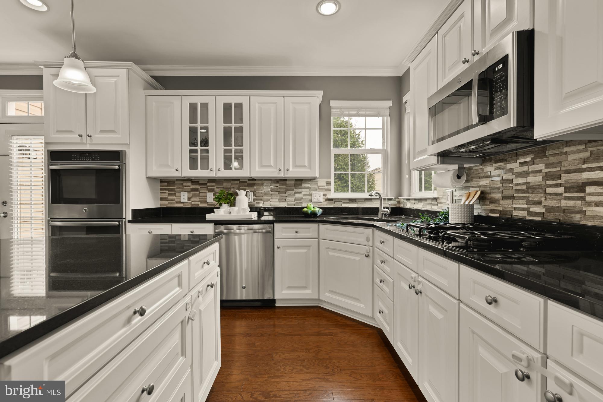 15611 Coolidge Avenue Silver Spring, MD 20906 - Photo 18 of 57 a kitchen with stainless steel appliances granite countertop a stove a sink and a microwave