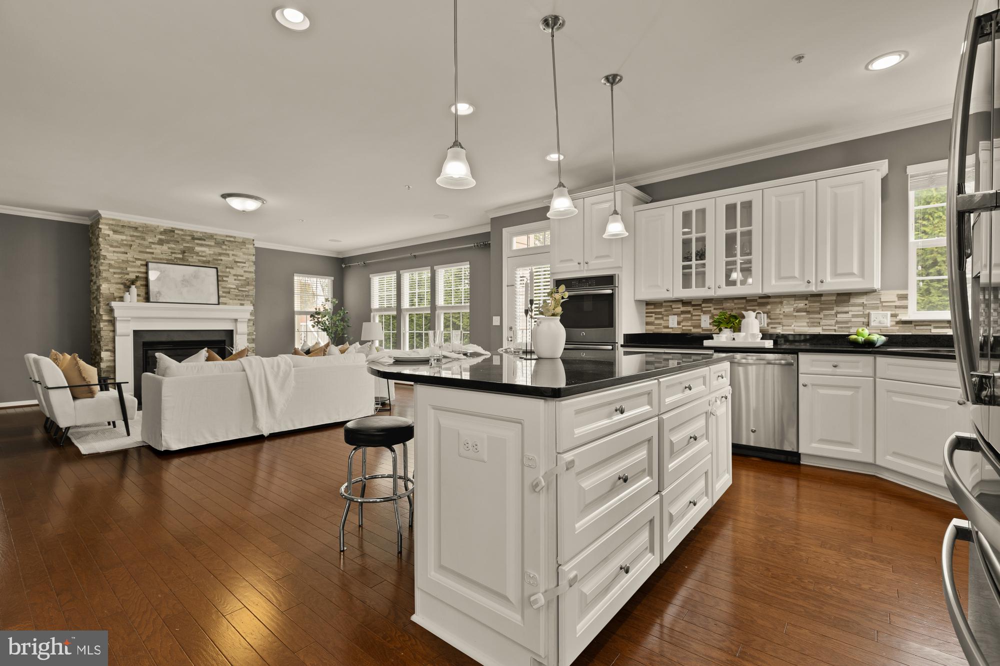 15611 Coolidge Avenue Silver Spring, MD 20906 - Photo 19 of 57 a kitchen with stainless steel appliances granite countertop a stove a sink dishwasher a dining table and chairs with wooden floor