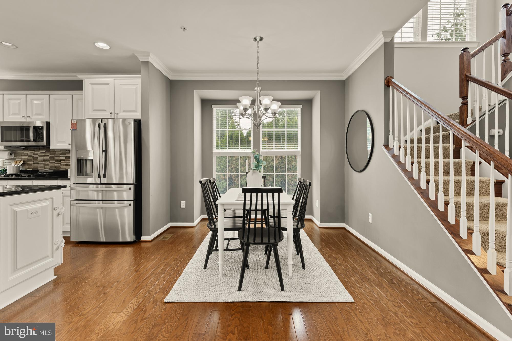 15611 Coolidge Avenue Silver Spring, MD 20906 - Photo 25 of 57 a view of a dining room with furniture a chandelier and wooden floor