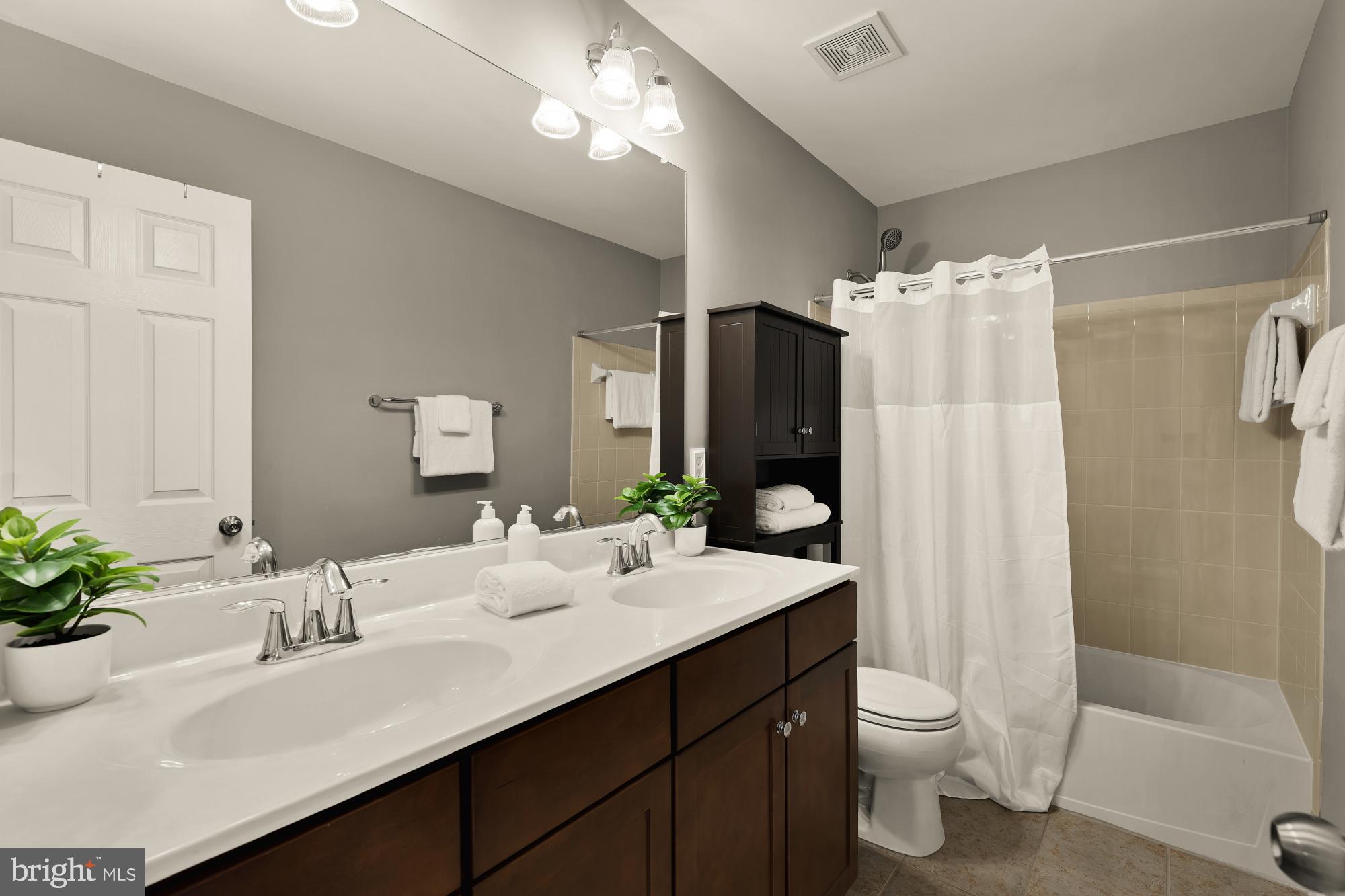 15611 Coolidge Avenue Silver Spring, MD 20906 - Photo 38 of 57 a bathroom with a double vanity sink toilet and shower