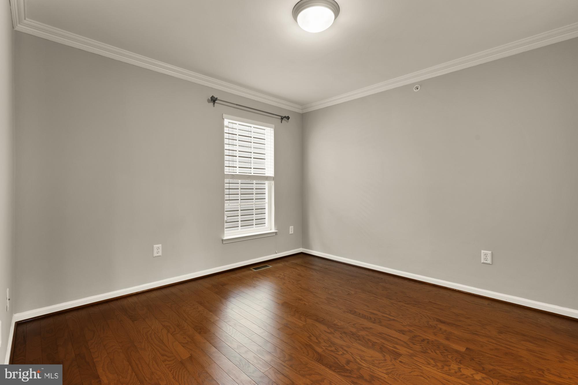 15611 Coolidge Avenue Silver Spring, MD 20906 - Photo 40 of 57 a view of an empty room with wooden floor and a window