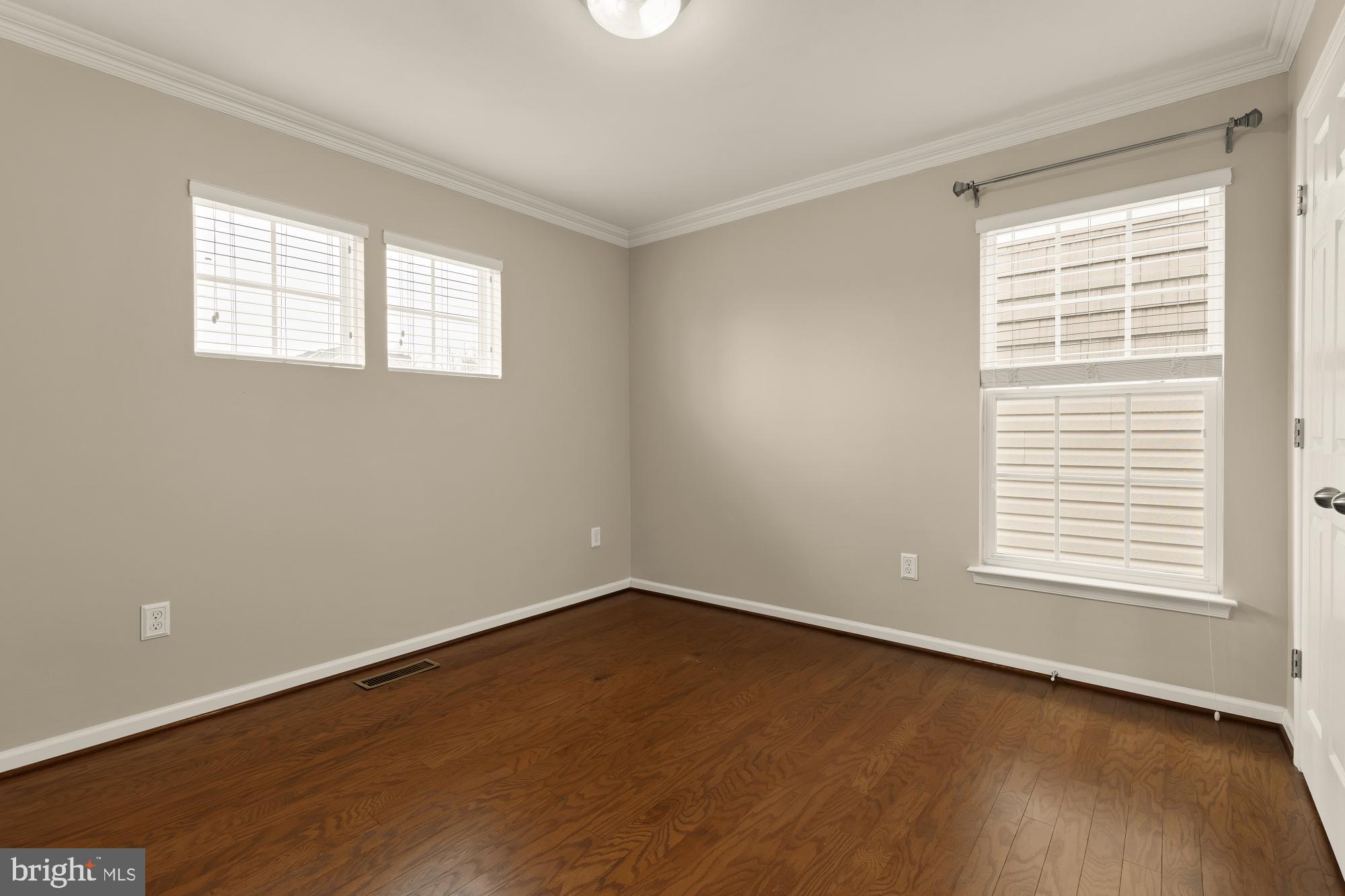 15611 Coolidge Avenue Silver Spring, MD 20906 - Photo 43 of 57 an empty room with wooden floor and windows