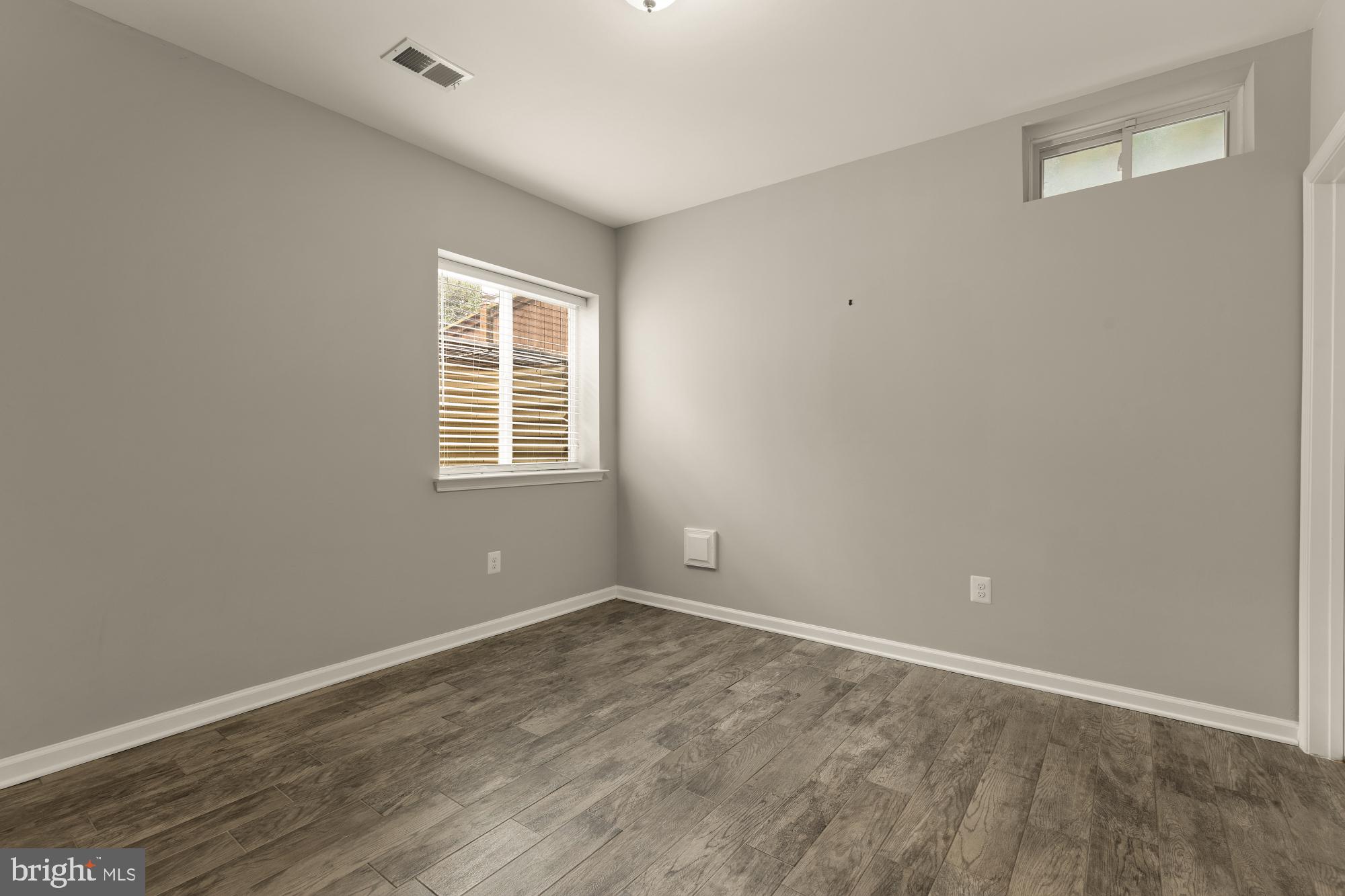 15611 Coolidge Avenue Silver Spring, MD 20906 - Photo 51 of 57 an empty room with wooden floor and windows