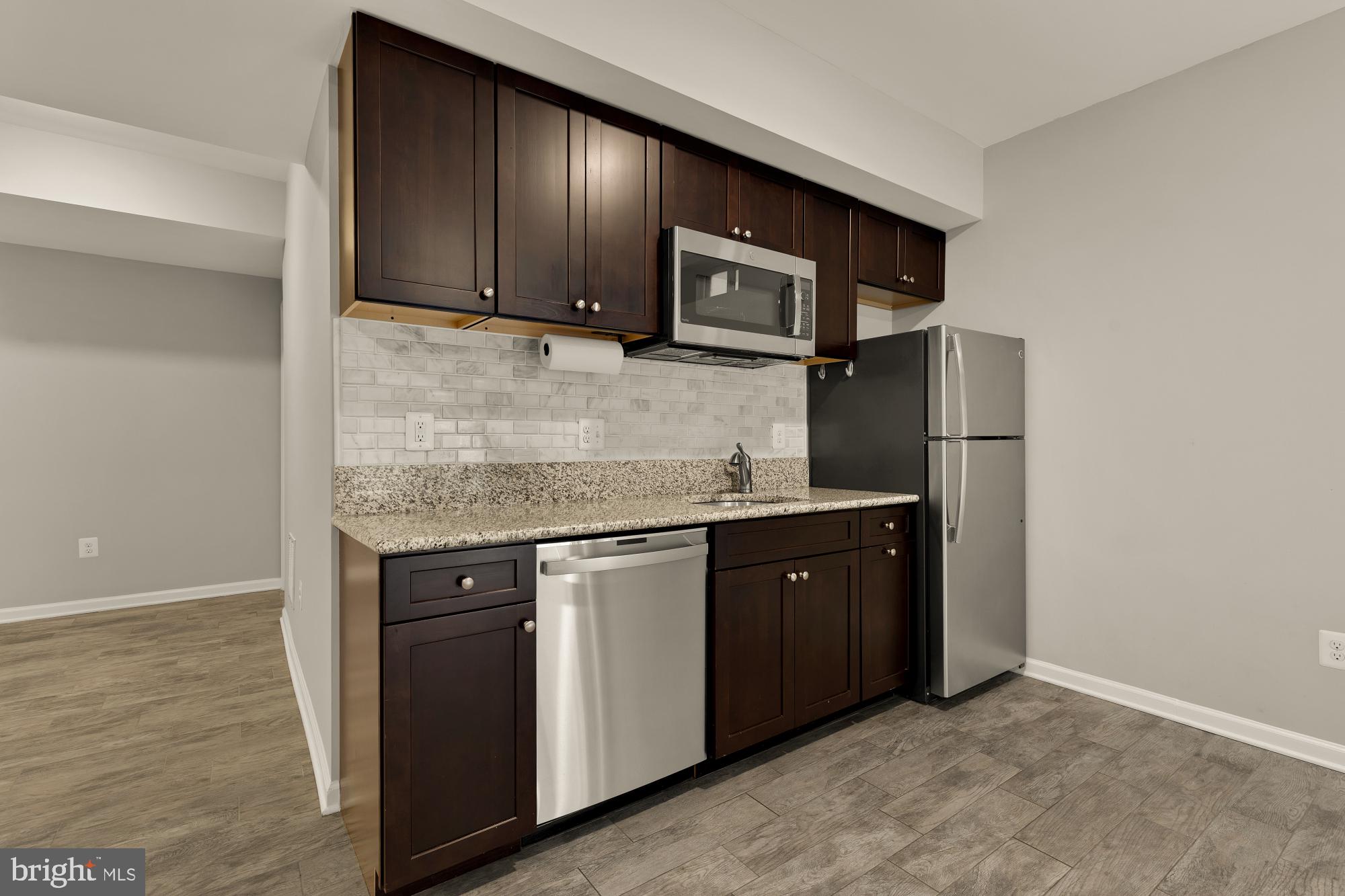 15611 Coolidge Avenue Silver Spring, MD 20906 - Photo 52 of 57 a kitchen with stainless steel appliances granite countertop a sink stove and microwave