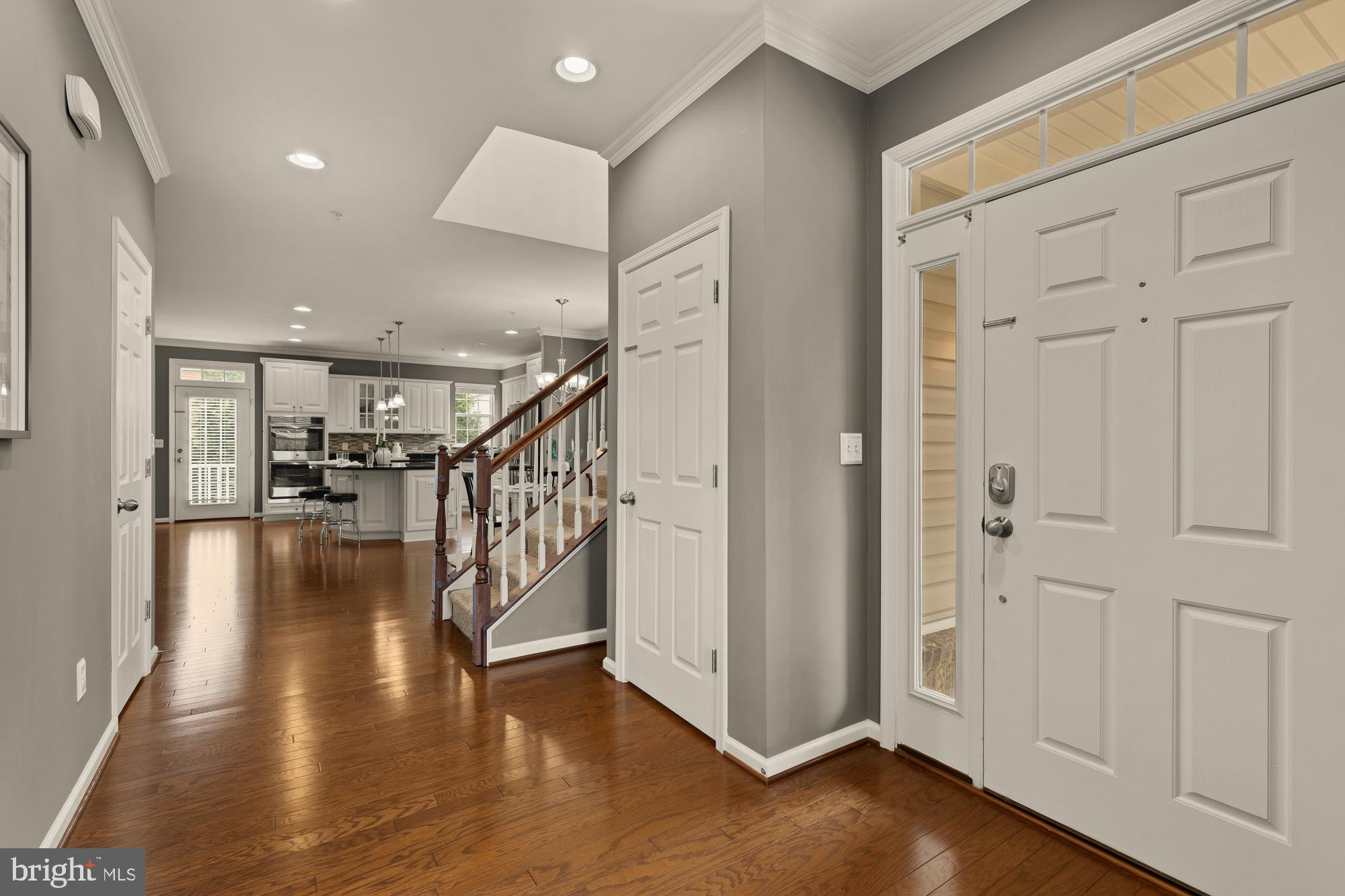15611 Coolidge Avenue Silver Spring, MD 20906 - Photo 7 of 57 a hallway with wooden floor windows and stairs
