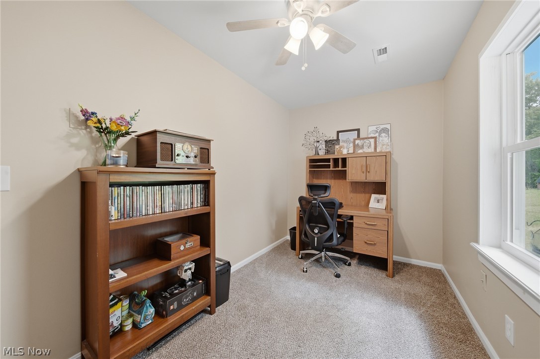 3471 State Rte 5 Newton Falls, OH 44444 - Photo 20 of 31 Room featuring neutral-toned walls, gray carpet, a ceiling fan with integrated lighting, and a white-framed window
