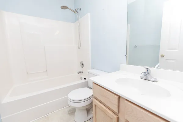 a bathroom with a sink a toilet and bathtub