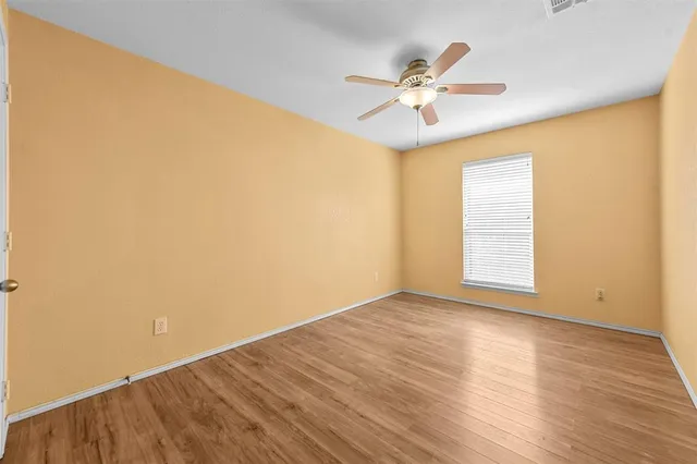 a view of an empty room and wooden floor