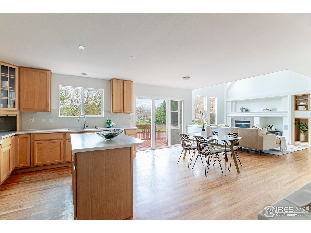 1414 Hoffman Drive Erie, CO 80516 - Photo 16 of 37 a kitchen with a table chairs and wooden floor
