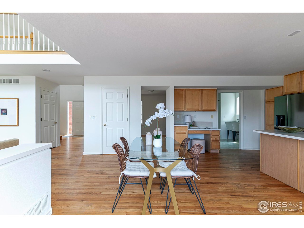 1414 Hoffman Drive Erie, CO 80516 - Photo 17 of 37 a living room with furniture a dining table and wooden floor