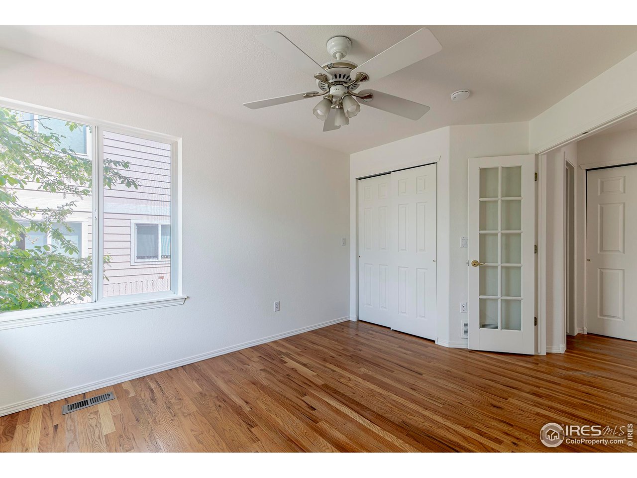 1414 Hoffman Drive Erie, CO 80516 - Photo 24 of 37 a view of an empty room with wooden floor and a window