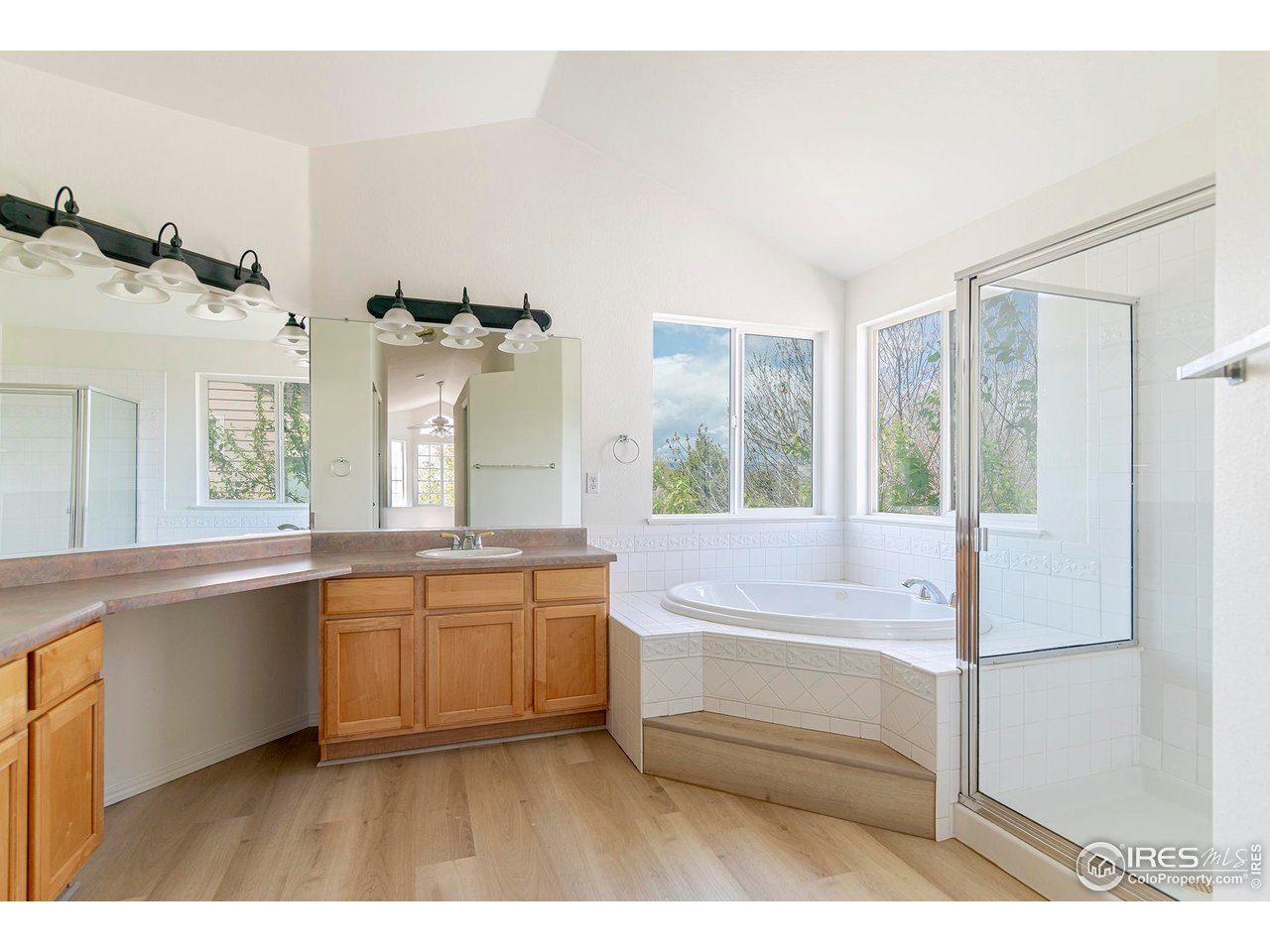 1414 Hoffman Drive Erie, CO 80516 - Photo 28 of 37 a bathroom with a tub sink and mirror