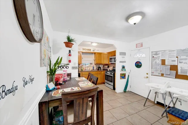 a very nice looking dining room with kitchen island granite countertop a table chairs and a stove