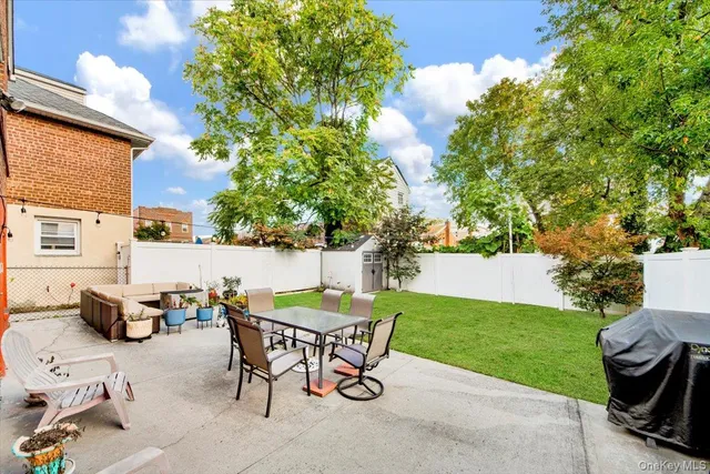 a view of a chairs and table in the back yard of the house