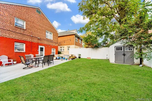 a view of backyard with table and chairs and potted plants