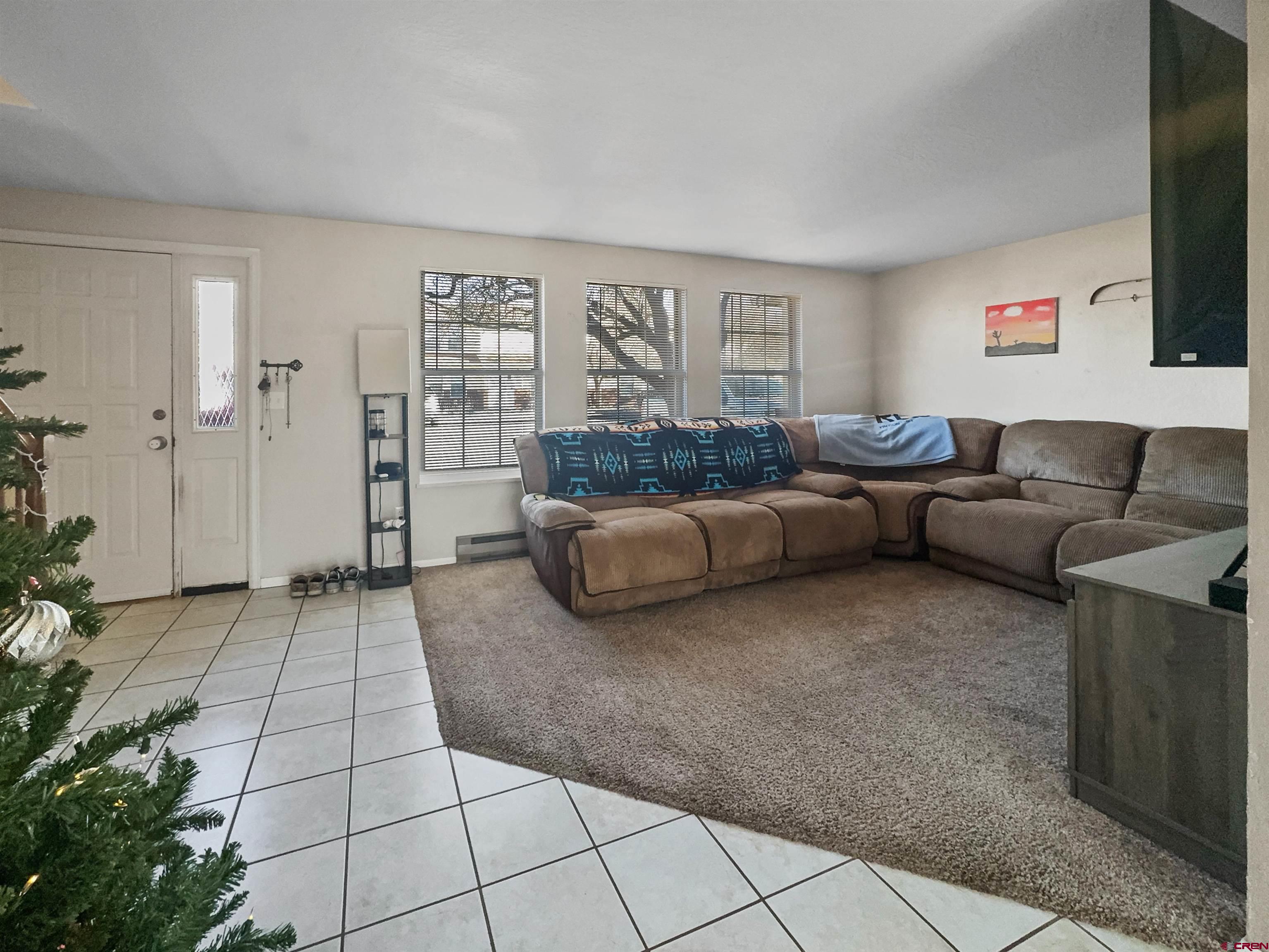 520 West 6th Street, Unit 15 Cortez, CO 81321 - Photo 5 of 22 a living room with furniture and a flat screen tv