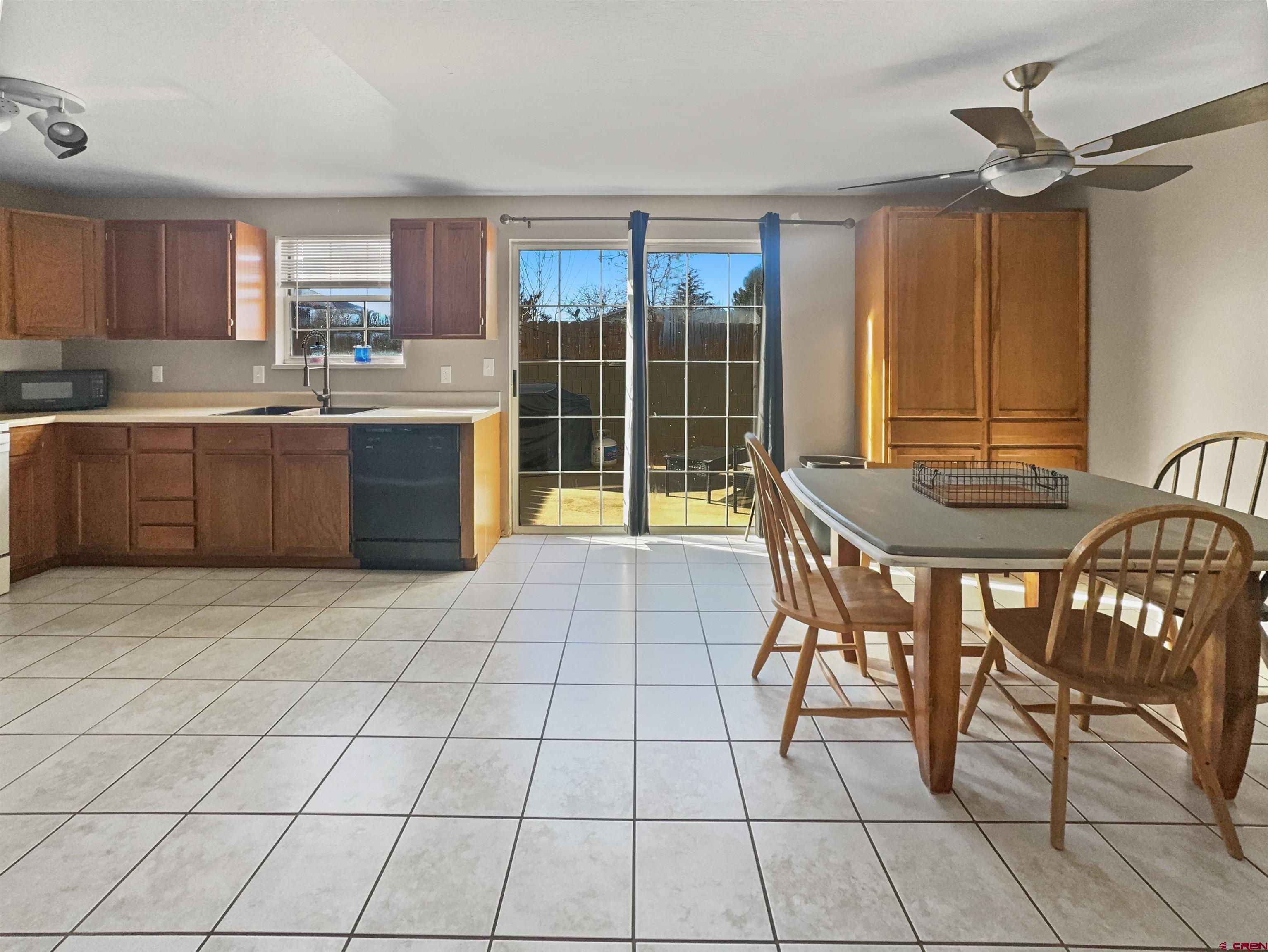 520 West 6th Street, Unit 15 Cortez, CO 81321 - Photo 6 of 22 a kitchen with granite countertop a sink cabinets and stainless steel appliances