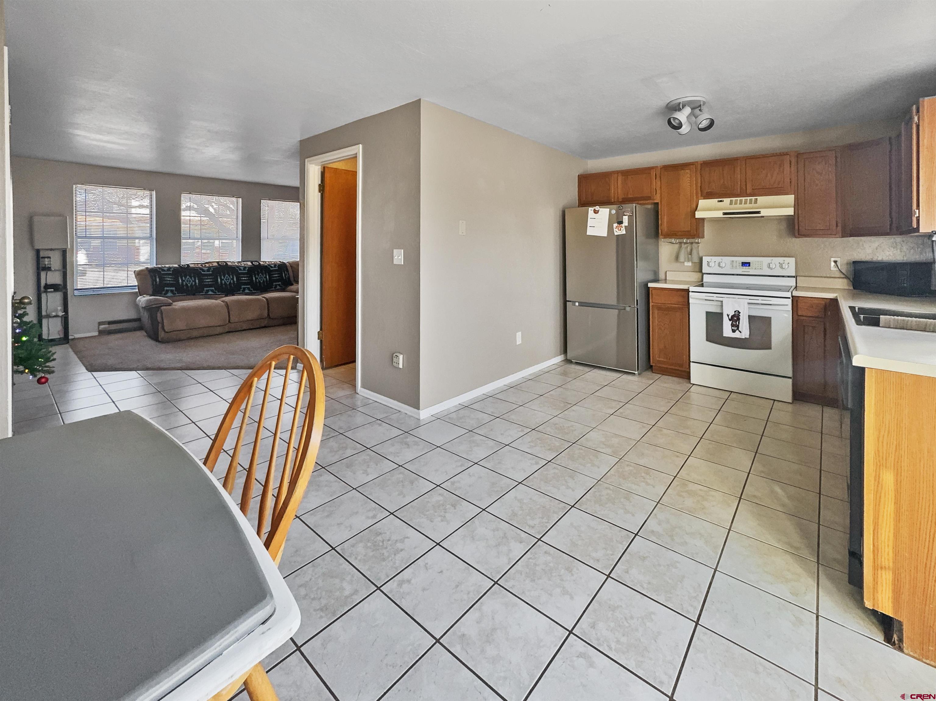 520 West 6th Street, Unit 15 Cortez, CO 81321 - Photo 8 of 22 a kitchen with stainless steel appliances granite countertop a refrigerator and a stove top oven